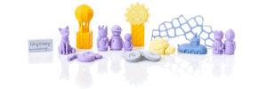 Image of some 3D printed toys standing next to each other (cat, turtle, people, sun etc)